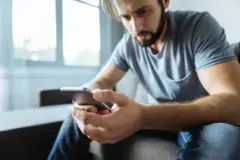 man waiting for his call and staring at his phone