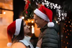 Couple on a date wearing Santa hats