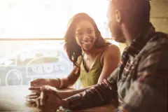 Smiling couple dating and sitting in a cafe