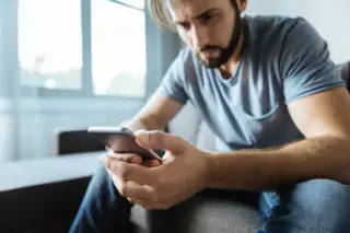 man waiting for his call and staring at his phone