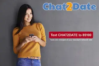 Woman holding mobile phone looking at the camera. Text says text CHAT2DATE to 85100