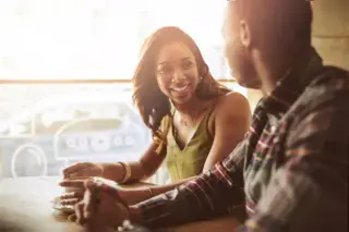 Smiling couple dating and sitting in a cafe