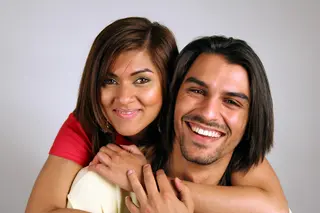 Portrait of a smiling Asian couple hugging