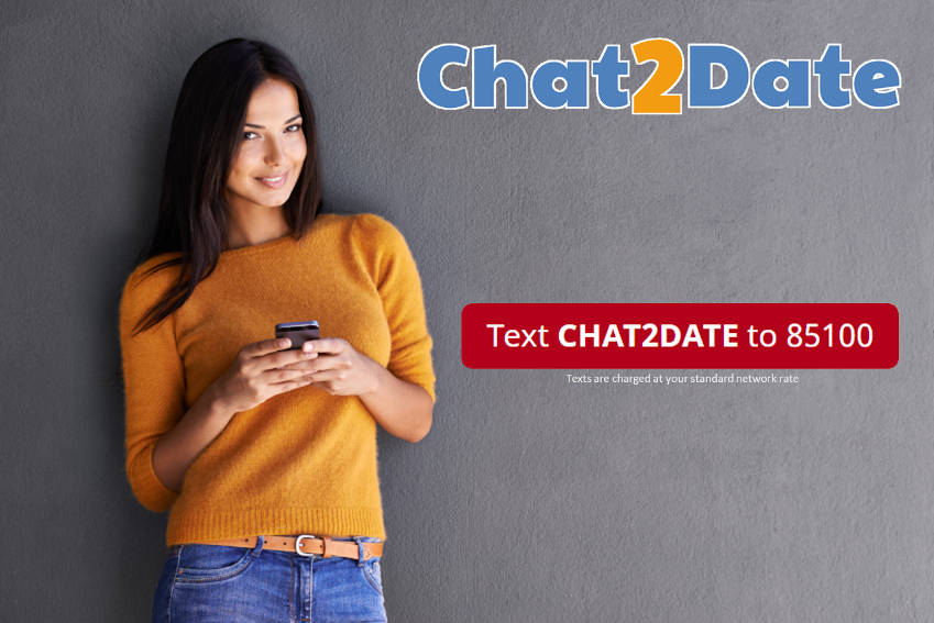 Woman holding mobile phone looking at the camera. Text says text CHAT2DATE to 85100