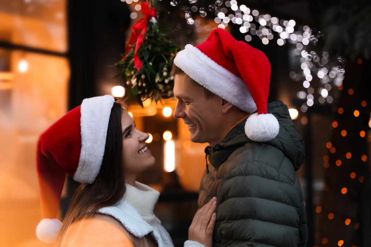Couple on a date wearing Santa hats