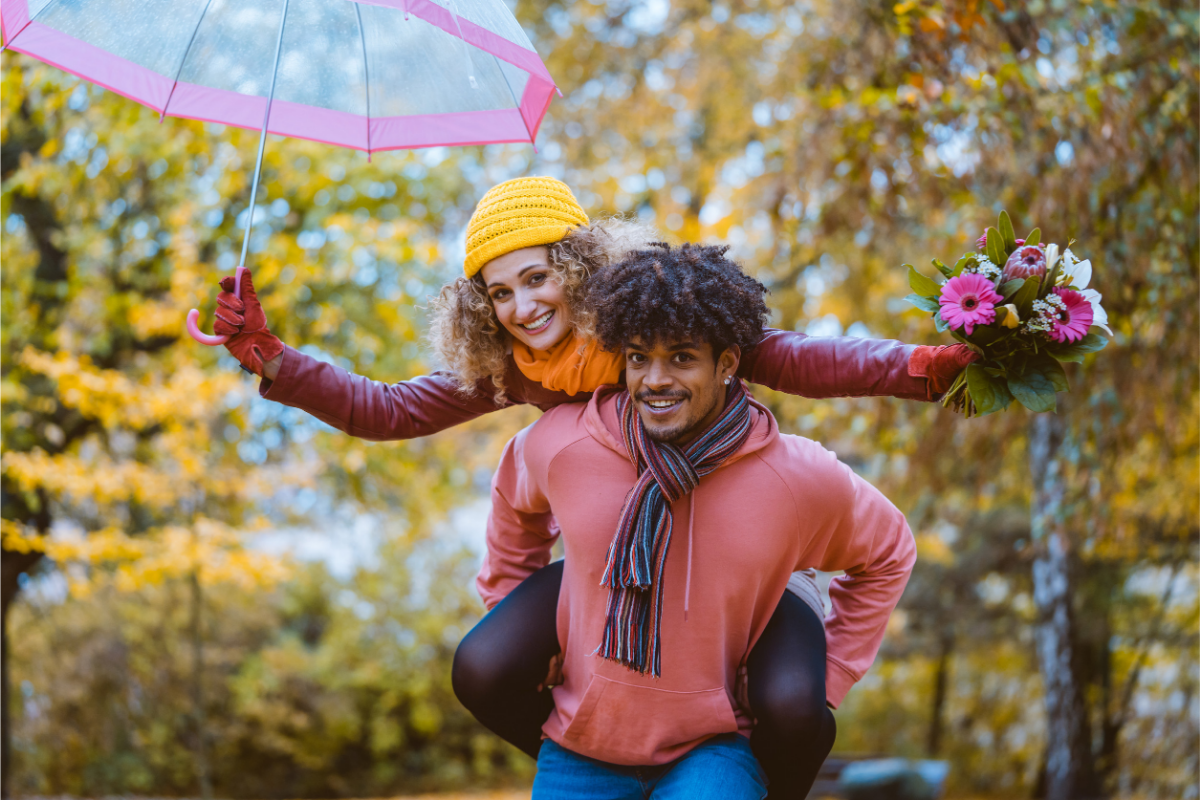 A man carrying a woman on his back in Autumn 
