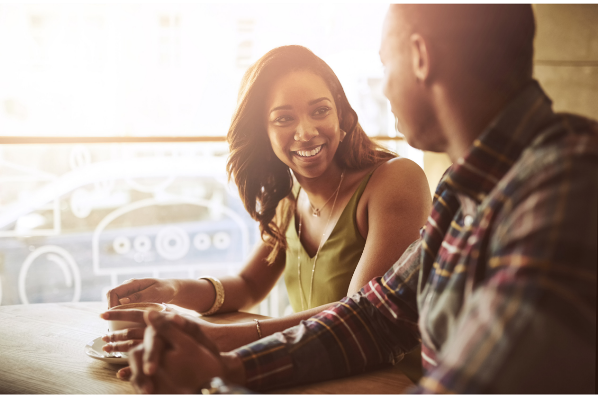 Smiling couple dating and sitting in a cafe 