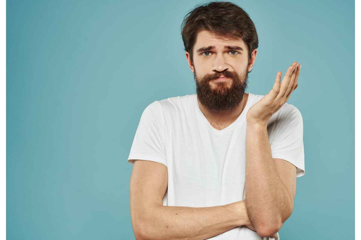 Man in a white shirt looking confused